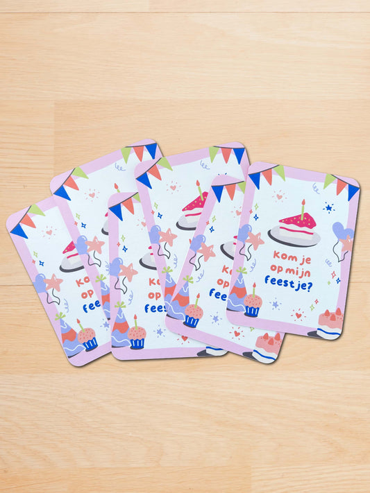Set of birthday-themed greeting cards on a wooden surface
