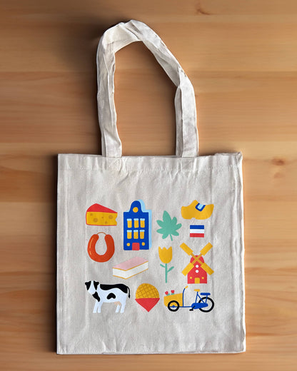 Tote bag with colorful illustrations of the Netherlands on a wooden surface