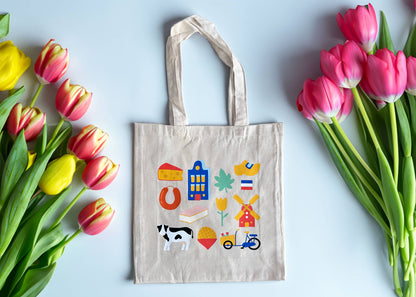Beige tote bag with colorful Dutch icons on a light blue background with tulips.