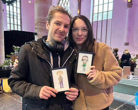 Two customers getting their portraits painted live in the theme of the Garden Lover.