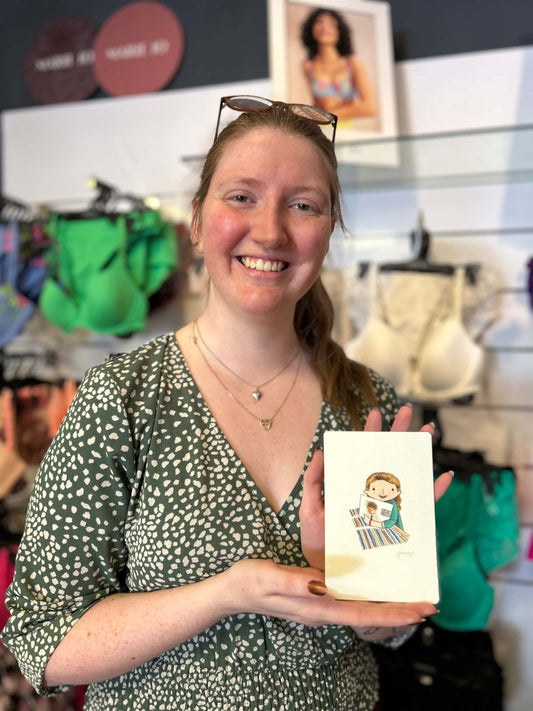 Photo of a blonde woman holding their live painting portrait