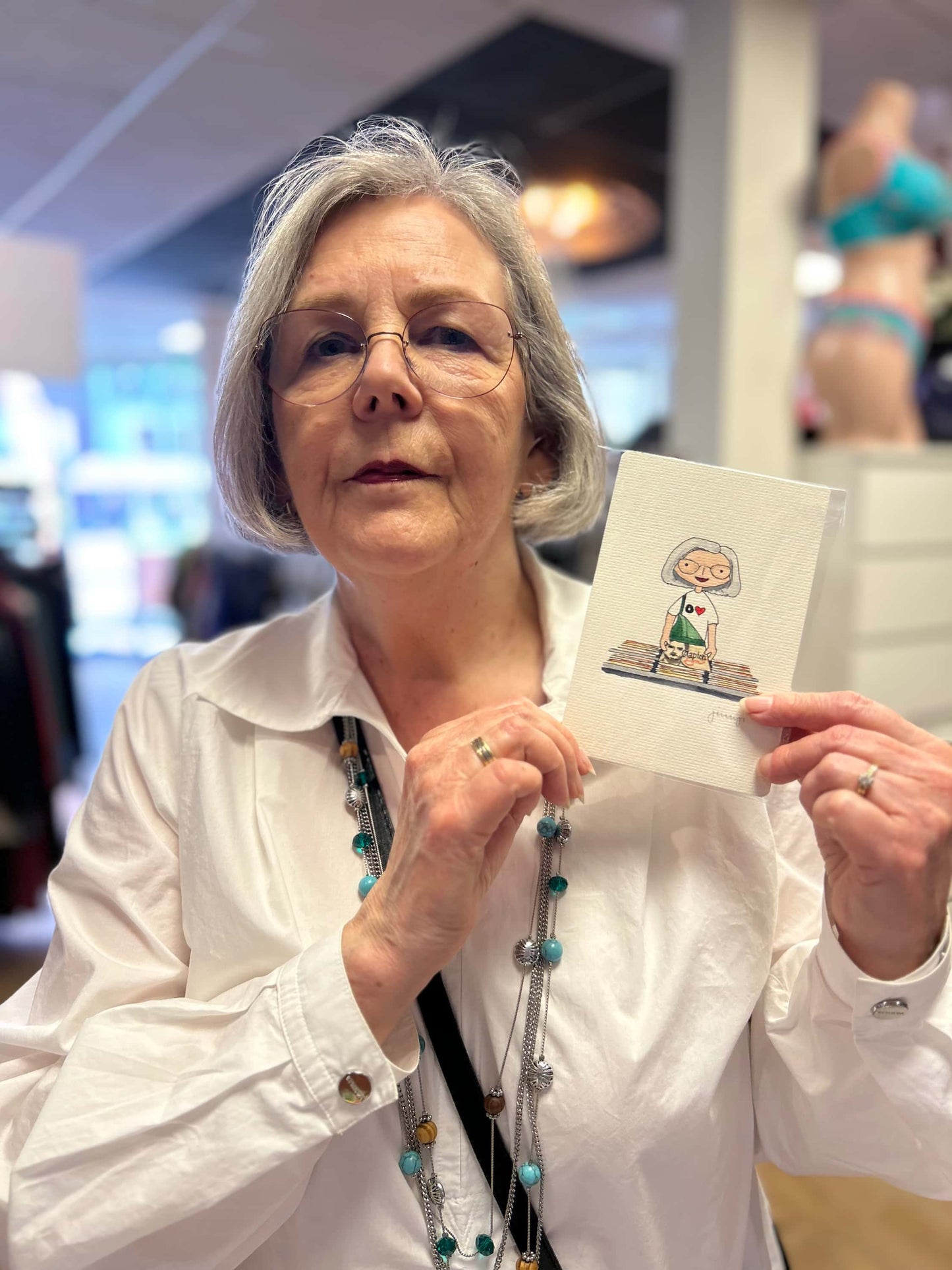 Lady holding up a custom portrait of herself based on the Music Lover theme