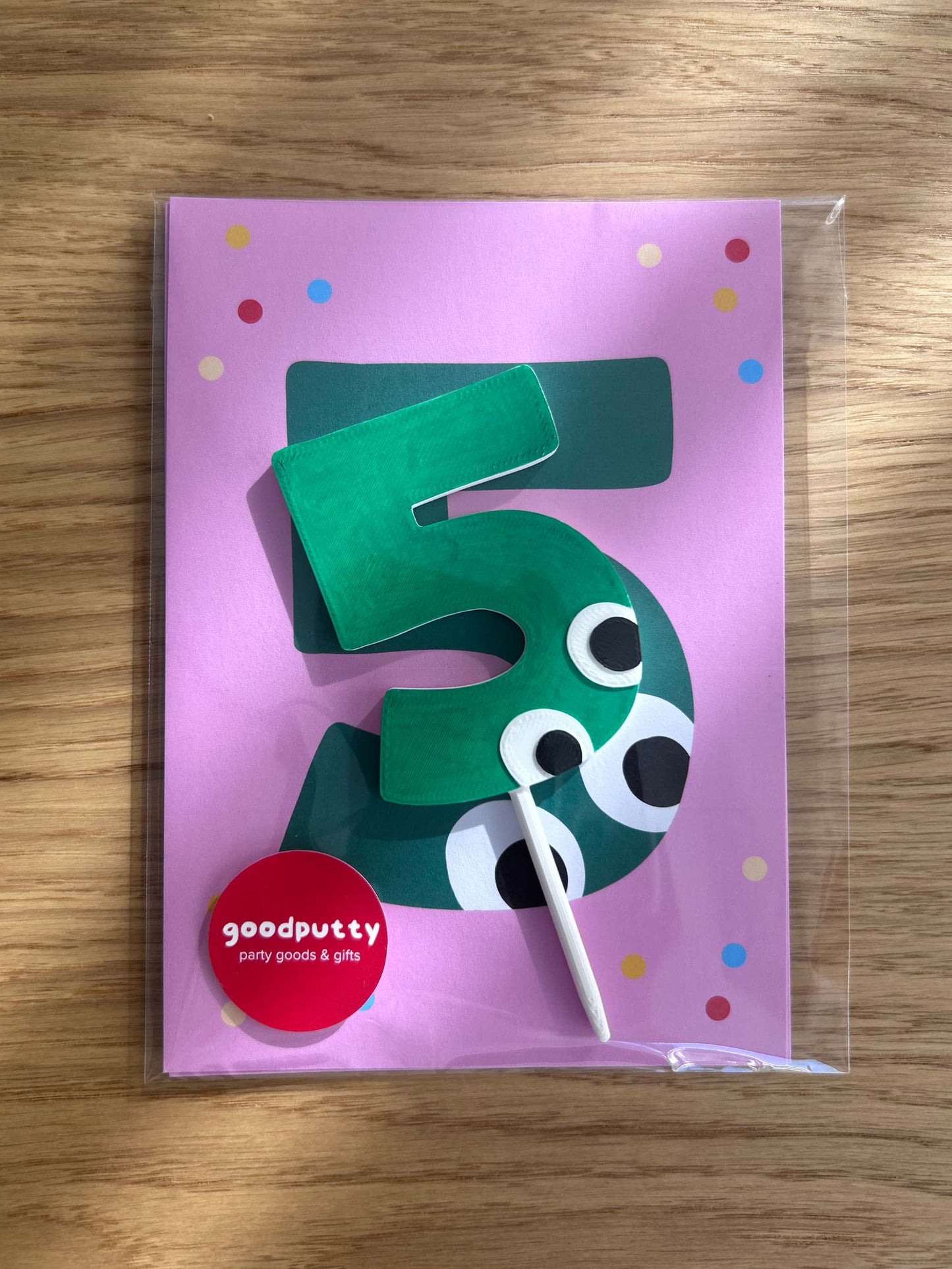 Green number 5 birthday party invitations with googly eyes on a pink card with polka dots, branded 'goodputty'.