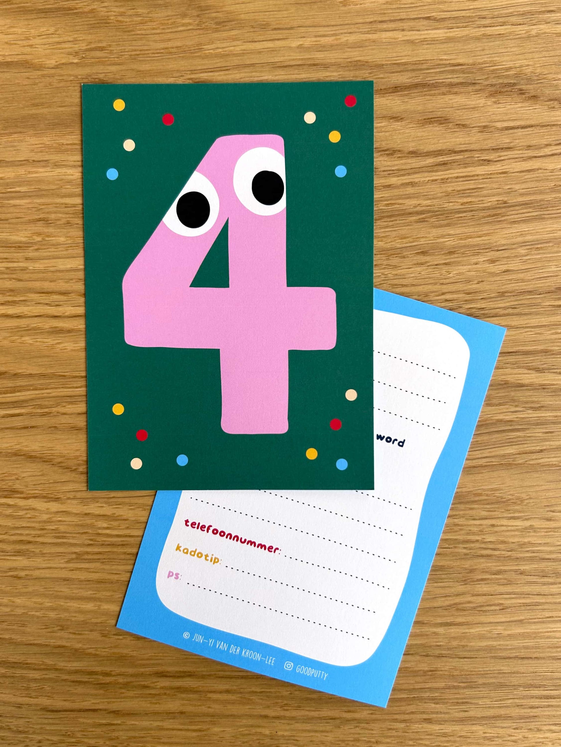 Colorful birthday invitation card for four year olds on a wooden surface
