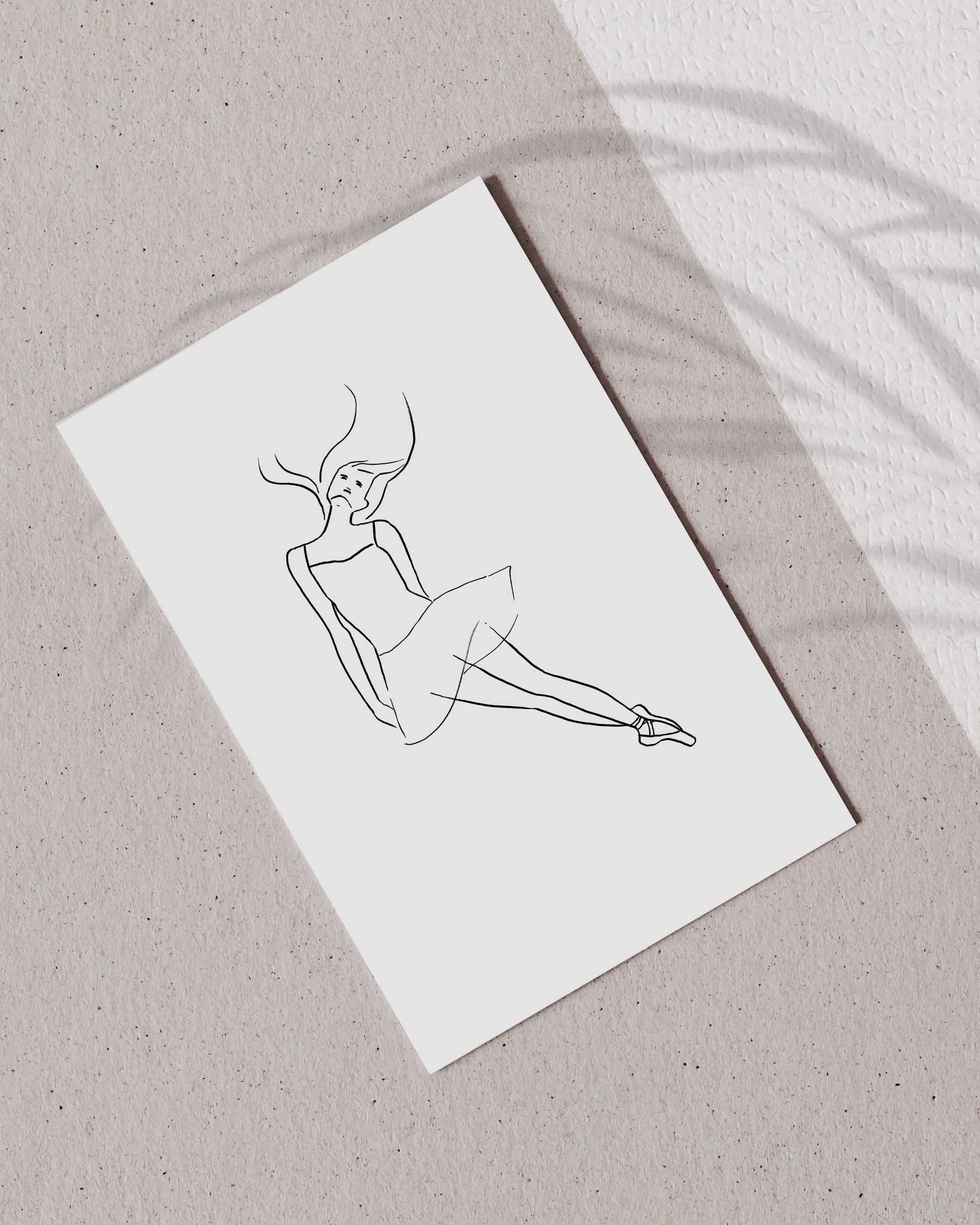 Line drawing of a ballerina on a white postcard with a beige background