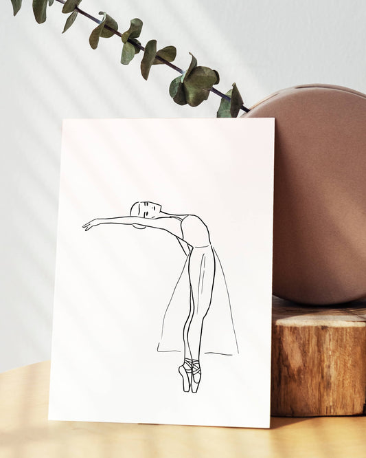 Line drawing of a dancer on a white card with a plant and wooden block in the background