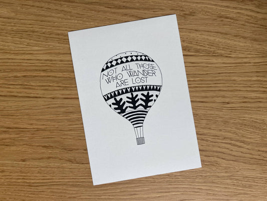 Art print with a black and white illustration of a hot air balloon and a traveller's quote by J.R.R. Tolkien