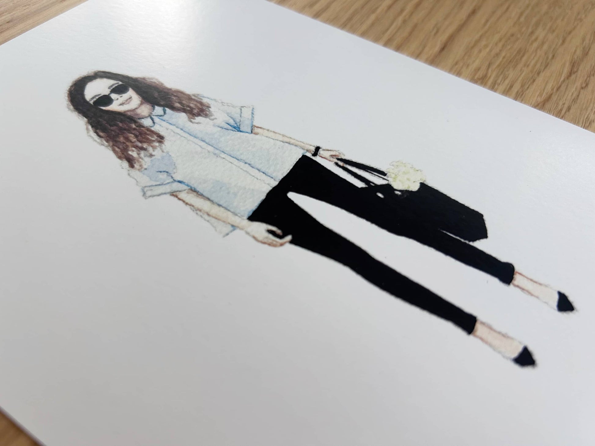 Watercolour illustration of a fashionable person wearing sunglasses on a white card
