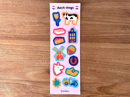 Sheet of colorful stickers with Dutch designs on a wooden surface