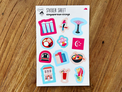 Sheet of Singapore-themed stickers on a wooden surface